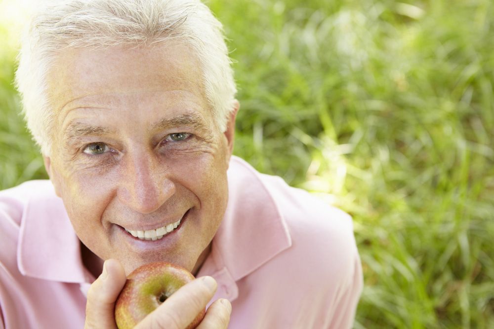 Photo of an older man with an apple